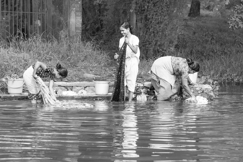 Clothes being washed in the backwaters of Kuttanad in Alappuzha district, Kerala